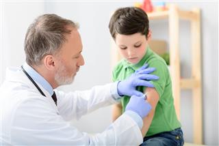 Doctor Pediatrician Injecting Vaccine