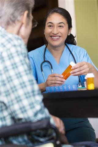Nurse Helps Senior Patient With Medication