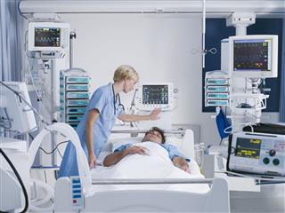 Nurse Tending Patient In Intensive Care