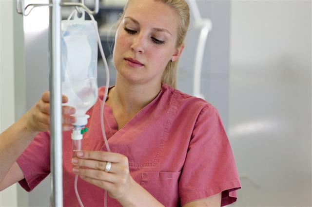 Female Nurse Preparing An Infusion