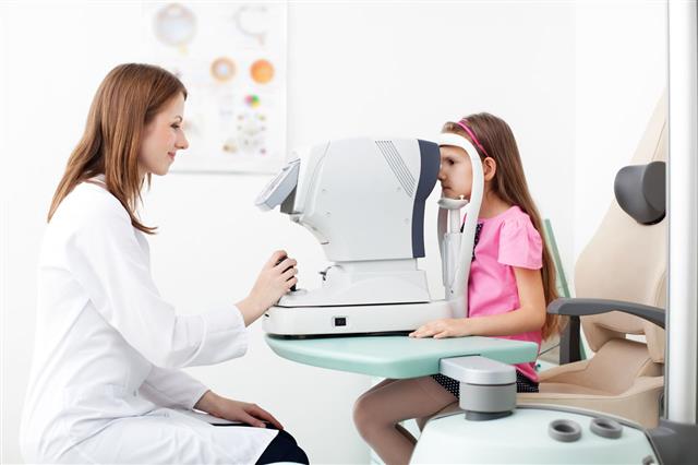 Optometrist Examines The Sight Of Girl