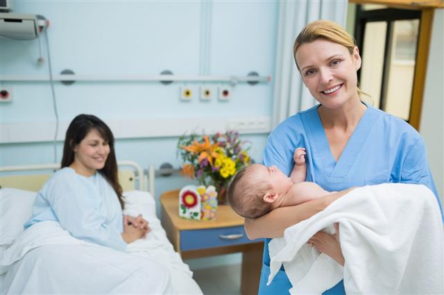 Nurse Holding A New Born Baby