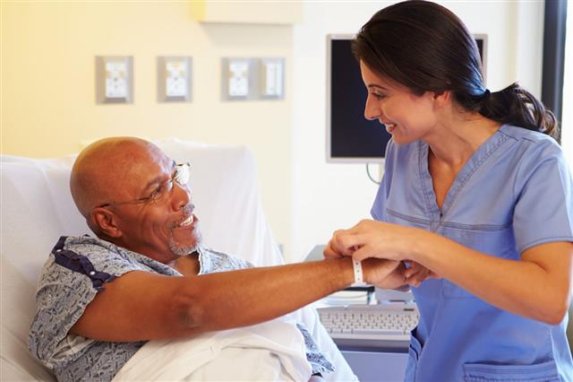 Nurse Putting Wristband On Male Patient