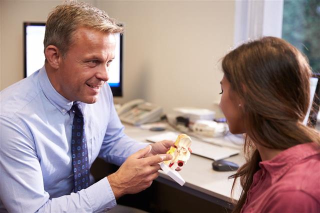 Doctor Shows Patient Human Ear Model