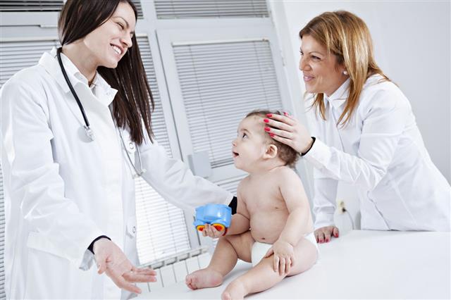 Pediatrician Doing Checkup On Baby