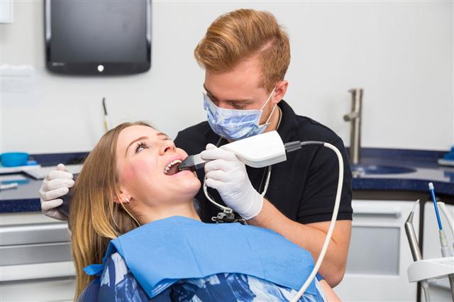Dentist Scanning The Teeth Of Patient