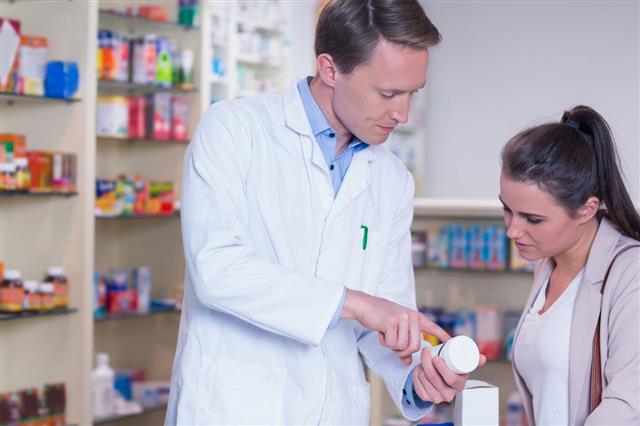Pharmacist Explaining The Pills To Patient