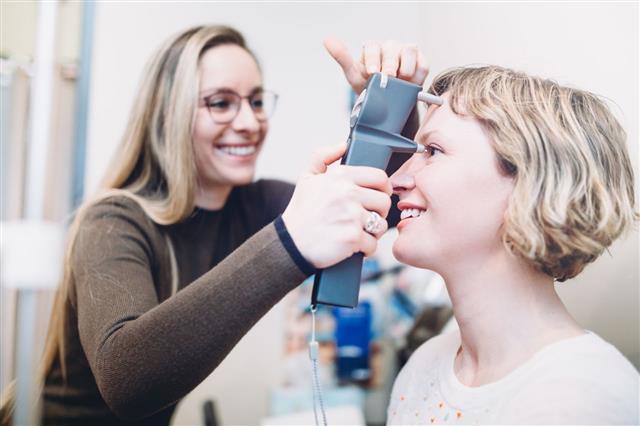 Female Optometrist Performs Eye Exam