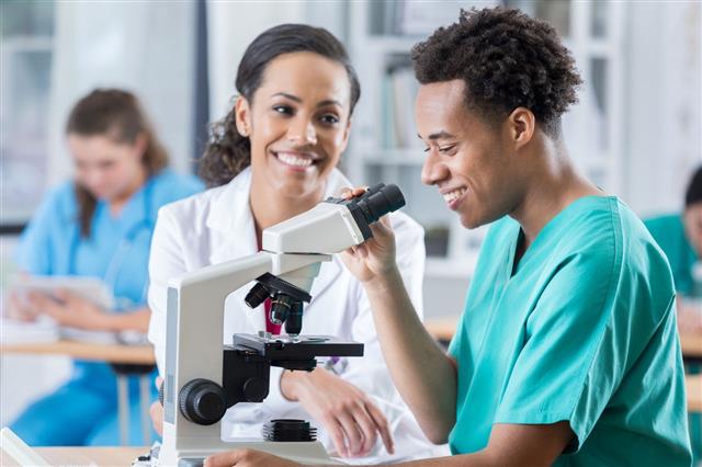 Medical Student Uses Microscope In Classroom