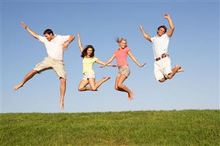 Young Couples Jumping In Air