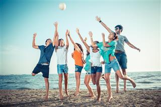 Group Of Friends Playing Beach Volleyball