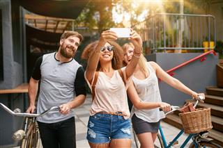 Young Woman With Friends Taking Selfie