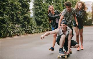 Friends Having Fun With Skateboard