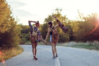 Beautiful Hipsters In Field At Sunset