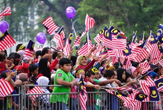 Crowd Waving A Malaysian Flags