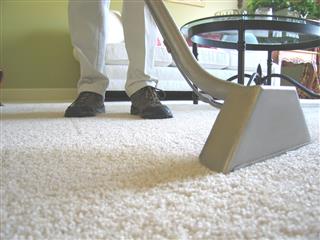 Man Cleaning White Carpet