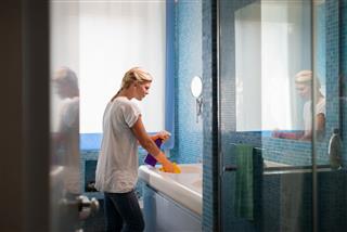 Woman Doing Chores And Cleaning Bathroom