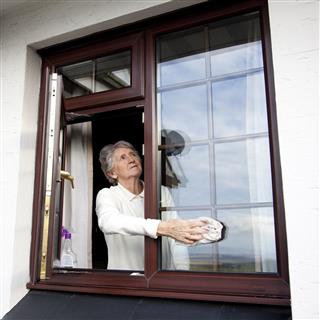 Senior Woman Cleaning Windows