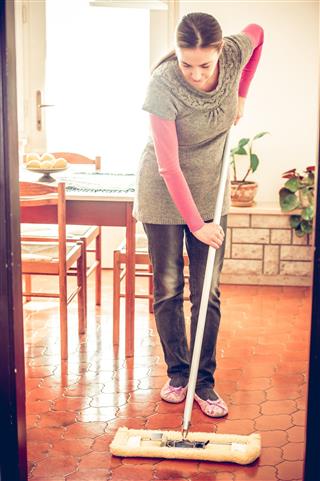 Woman Mopping Dining Room Floor