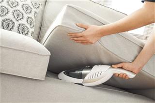 Woman With Handheld Vacuum Cleaning