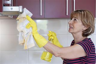 Mature Woman Cleaning A Kitchen