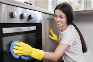 Woman Polishing Oven