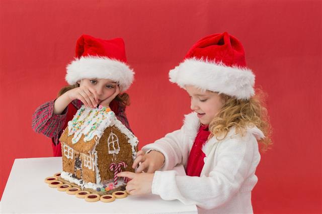 Girls Making A Gingerbread House