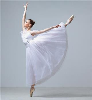 A Ballet Dancer Against A Gray Wall