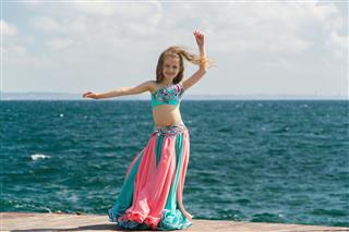 Young Girl Belly Dancer Performs At Sea