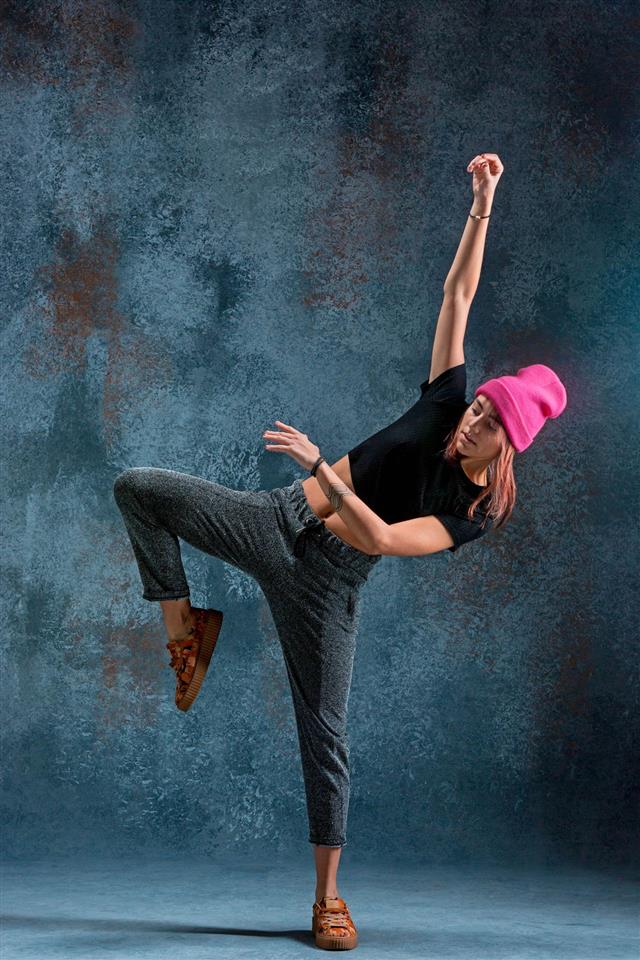 Young Girl Break Dancing On Wall Background