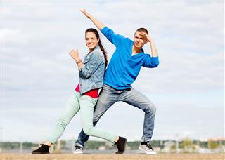 Couple Of Teenagers Dancing Outside