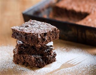 Stacked Pieces Of Brownies With Powdered Sugar