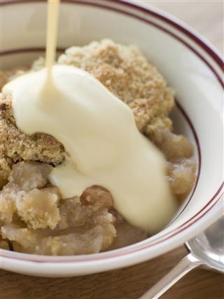 Bowl Of Apple Crumble With Custard