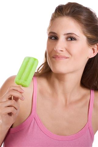 Young Woman Eating Green Frozen Sorbet