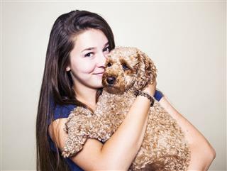 Teenage Girl Holding A Poodle