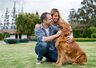 Couple Having Fun With Their Dog