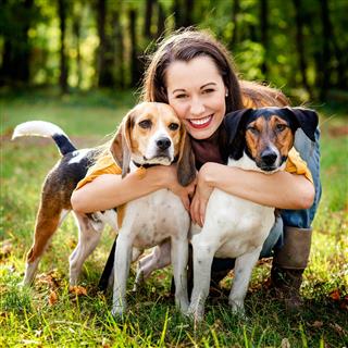 Smiling Brunette Female And Her Dogs