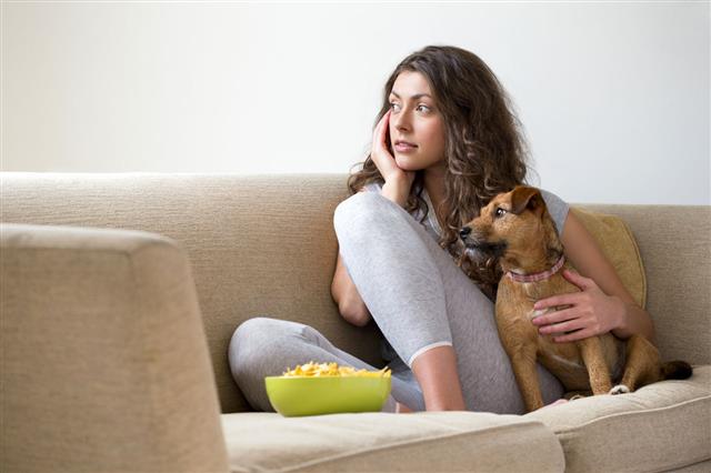Woman Relaxing At Home With Dog