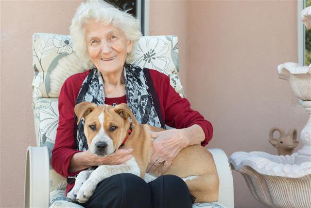 Senior Woman Loving Dog