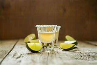 Gold Tequila Shots On Rustic