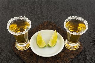 Two Gold Tequila Shots With Lime