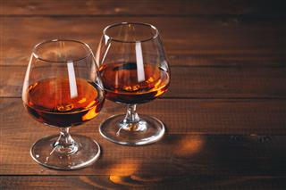Two Glasses Of Cognac On Table