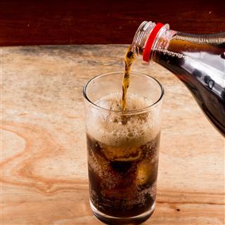 Pouring Cola Into The Glass