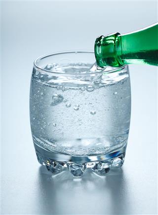 Mineral Water Pouring Into Glass