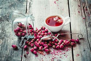 Rose Buds With Cup Of Tea