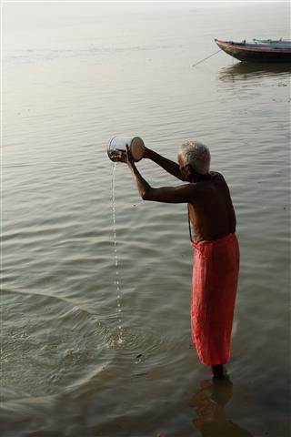 Praying Man In Ganges River