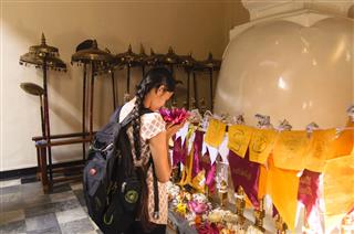 Girl Praying At Buddhist Temple