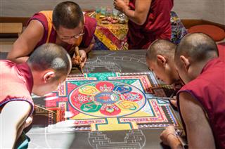 Tibetan Monks Making A Mandala