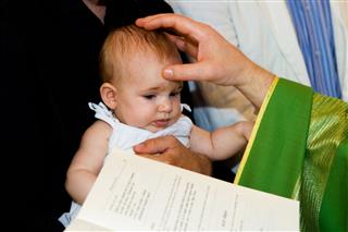 Priest Is Baptizing Little Baby