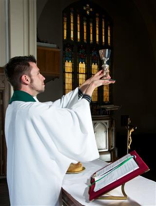 Altar Scene With Priest Blessing Wine